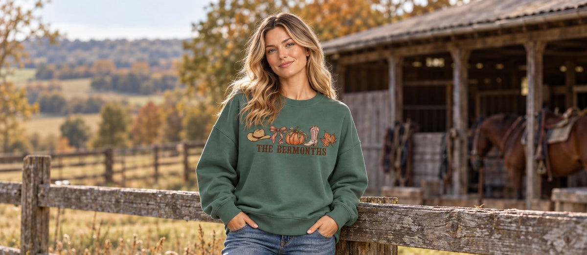 Country western model wearing green sweater with the words The Bermonths, with images of a pumpkin, autumn leaves, cowboy boots and cowboy hat 