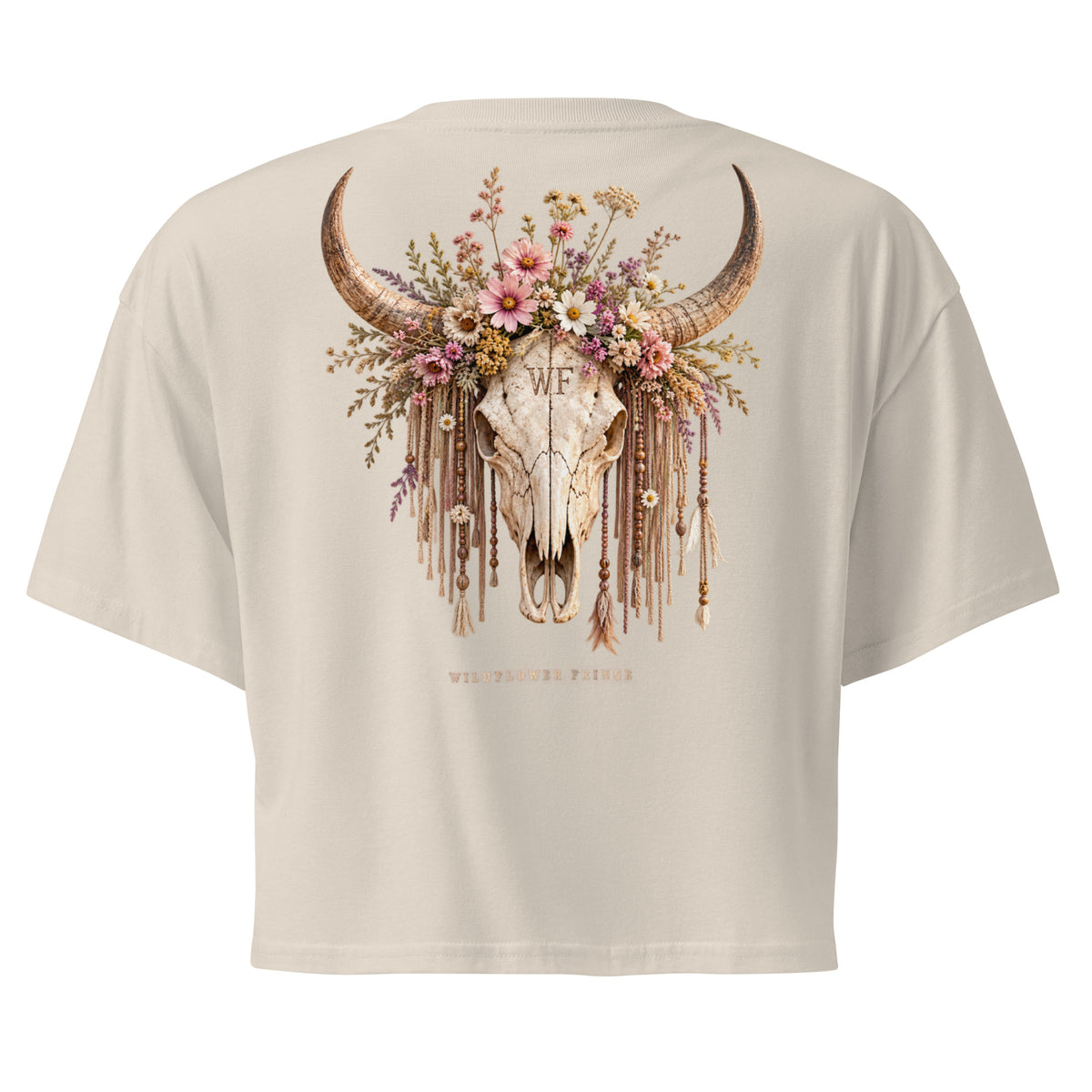 A light beige short-sleeve t-shirt shown from the back, featuring a large graphic of a decorated longhorn skull with a floral crown and hanging tassels.