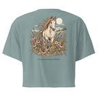 A sage green short-sleeve t-shirt shown from the back, featuring a large graphic print of a white horse running through wildflowers under a full moon, with the text 'WILDFLOWER FRINSE' printed below.
