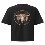 A black short-sleeve t-shirt shown from the back, featuring a large graphic print of a decorated bull skull with feathers and flowers, surrounded by the text 'COUNTRY FOLK WILD & FREE' and 'WILDFLOWER PRINTS'.